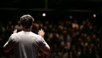 6 things every career coach wants you to know third culture Africans man talking to the crowd with his 2 hands lifted